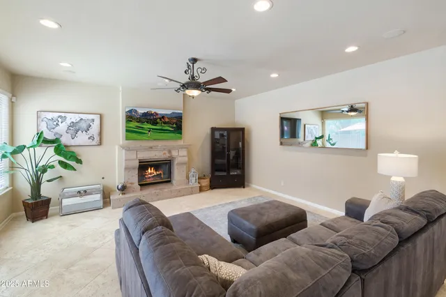 a living room with furniture a fireplace and a flat screen tv