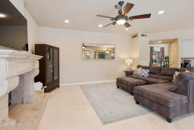 a living room with furniture a large window and chandelier