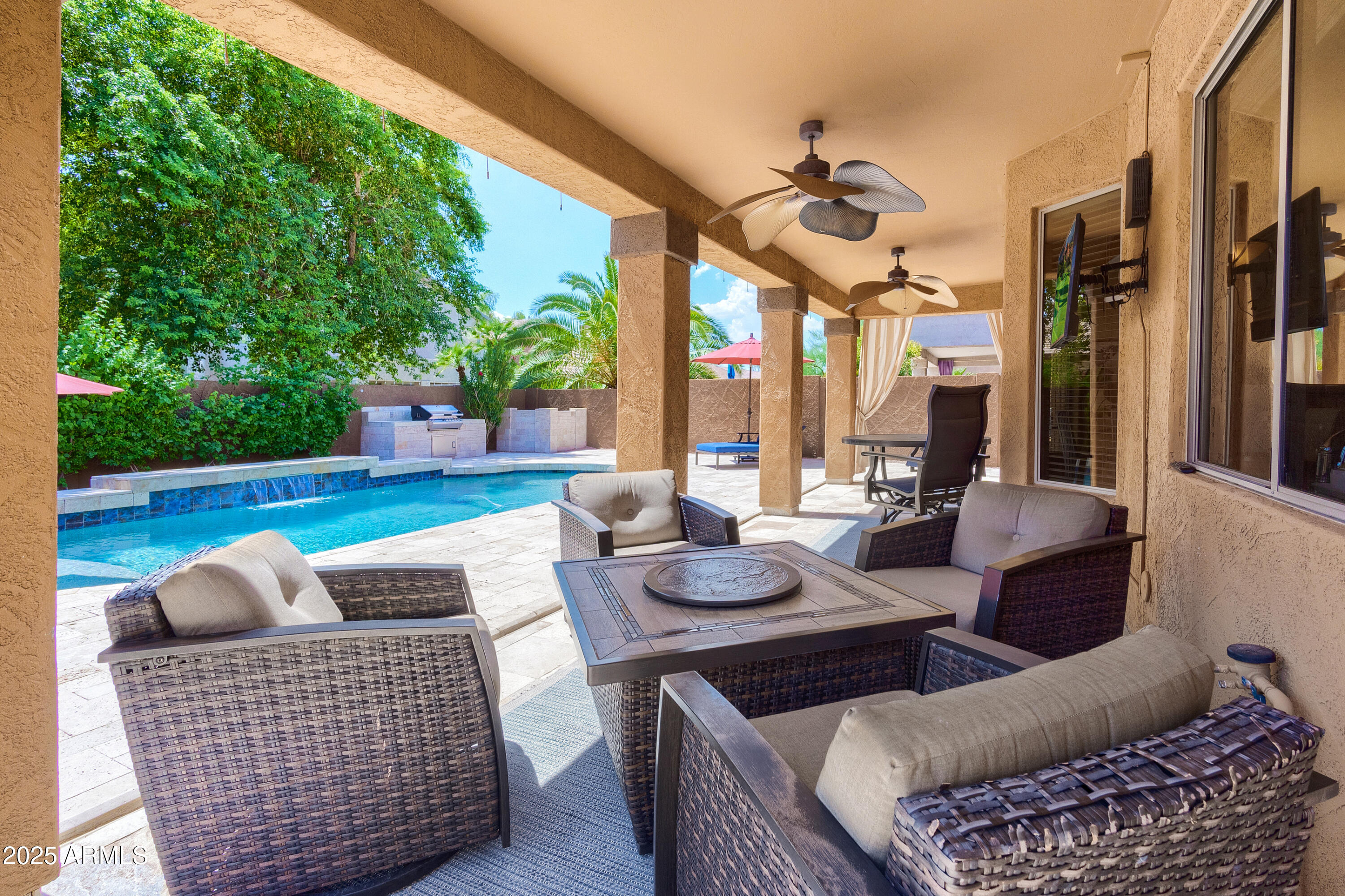 6419 East Betty Elyse Lane Scottsdale, AZ 85254 - Photo 20 of 33 a outdoor living space with furniture and a fireplace