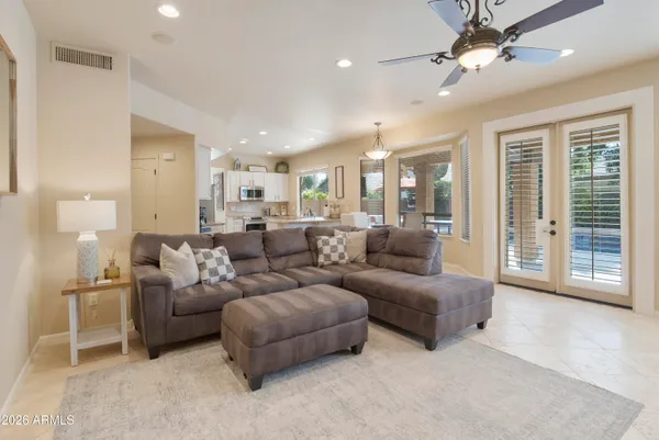 a living room with furniture and a chandelier