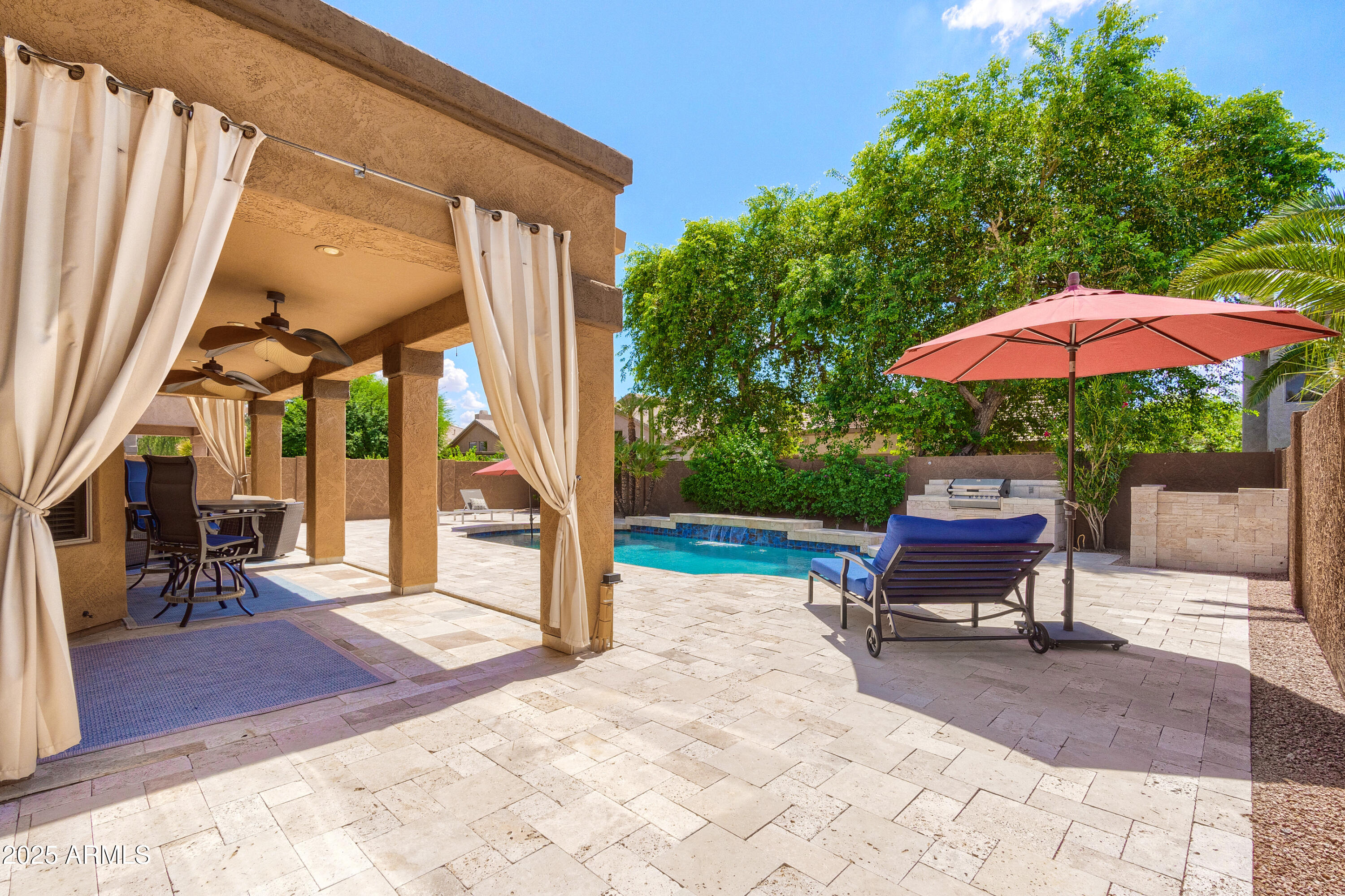 6419 East Betty Elyse Lane Scottsdale, AZ 85254 - Photo 22 of 33 a view of a patio with a table chairs and a barbeque