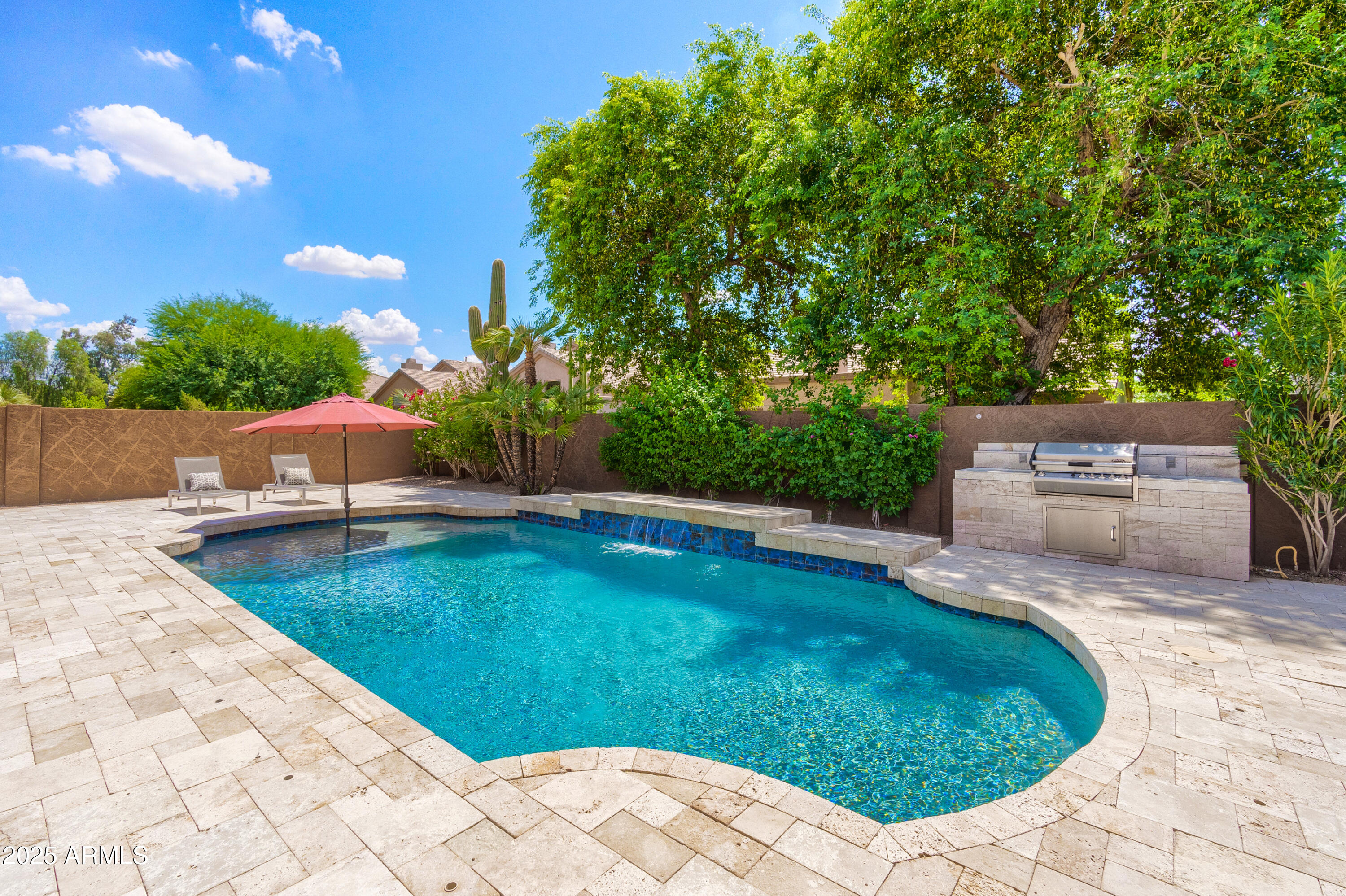 6419 East Betty Elyse Lane Scottsdale, AZ 85254 - Photo 26 of 33 a view of a swimming pool with a patio and plants