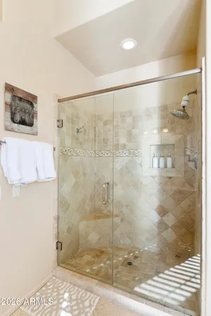 a bathroom with a granite countertop bathtub sink vanity and mirror