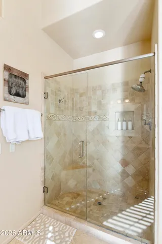 a bathroom with a granite countertop bathtub sink vanity and mirror