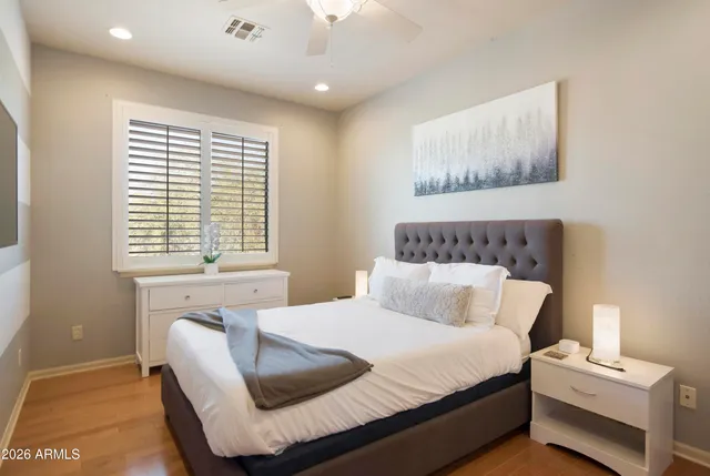 a view of a swimming pool with a lawn chairs under an umbrella
