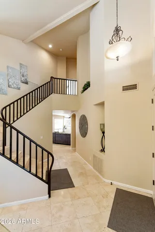 a view of a hallway with wooden floor and windows