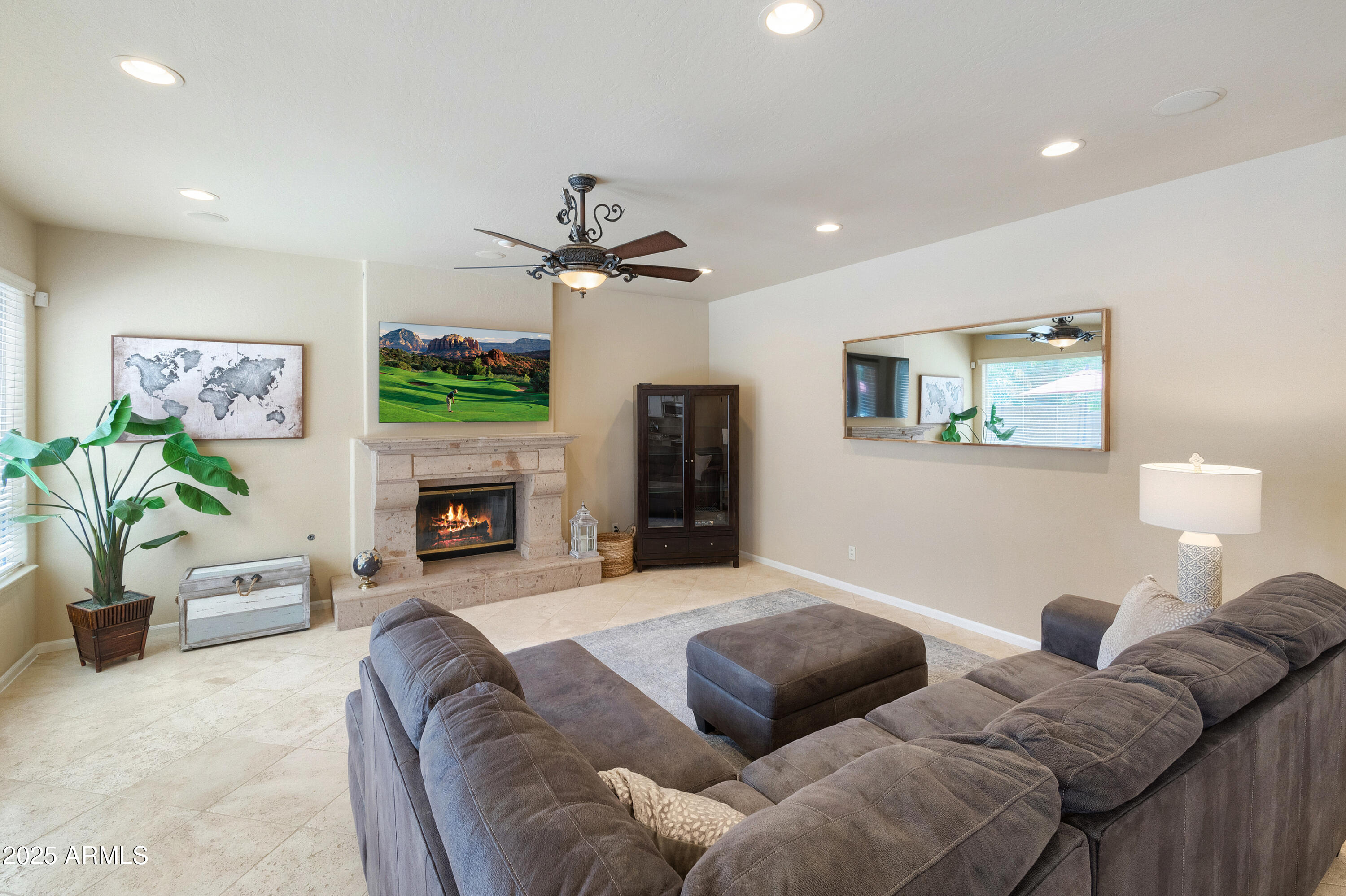 6419 East Betty Elyse Lane Scottsdale, AZ 85254 - Photo 4 of 33 a living room with furniture a fireplace and a flat screen tv
