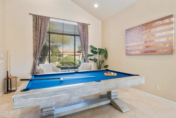 a room with pool table and glass door