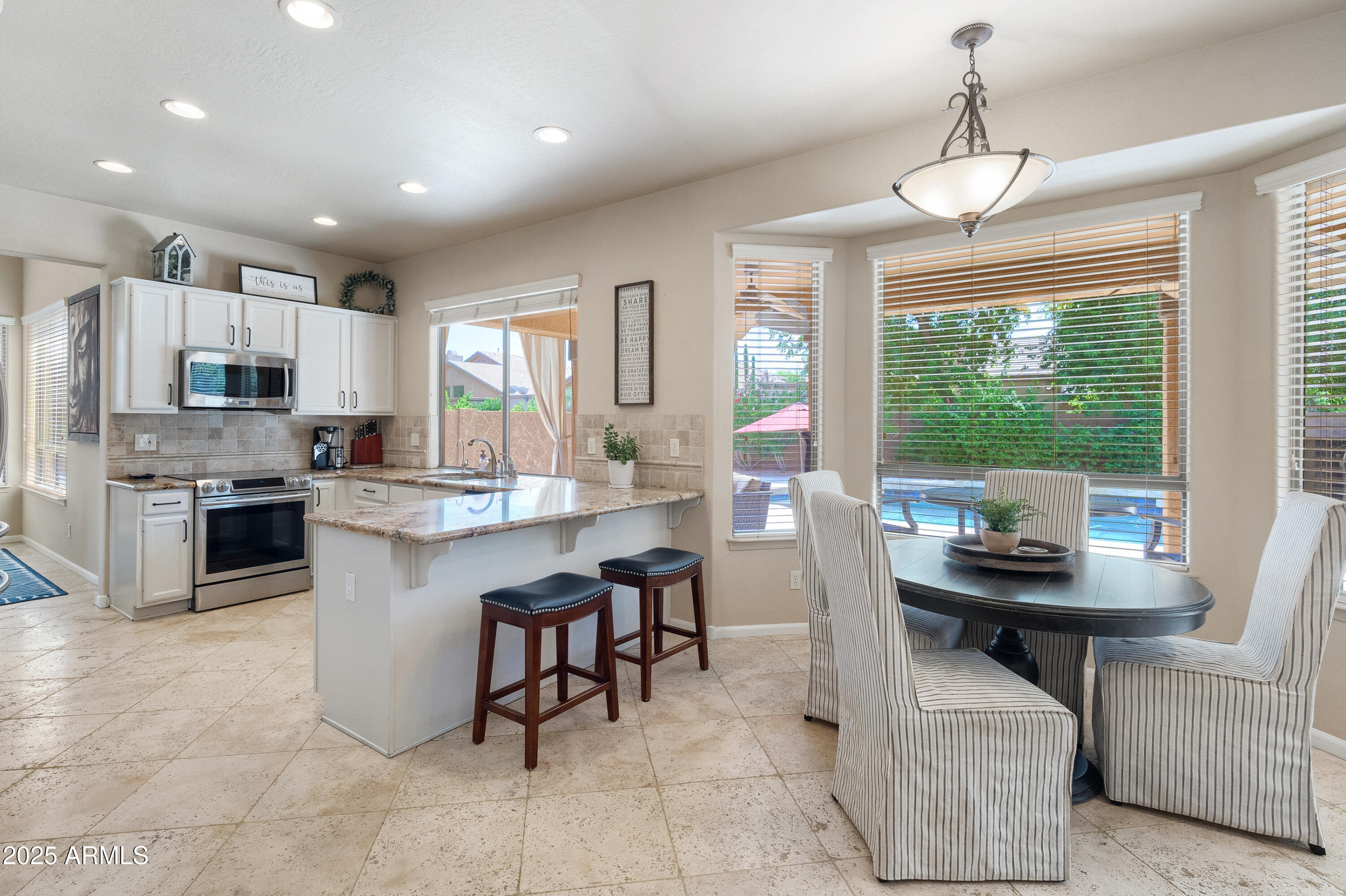 6419 East Betty Elyse Lane Scottsdale, AZ 85254 - Photo 7 of 33 a kitchen with kitchen island granite countertop furniture and a counter top space