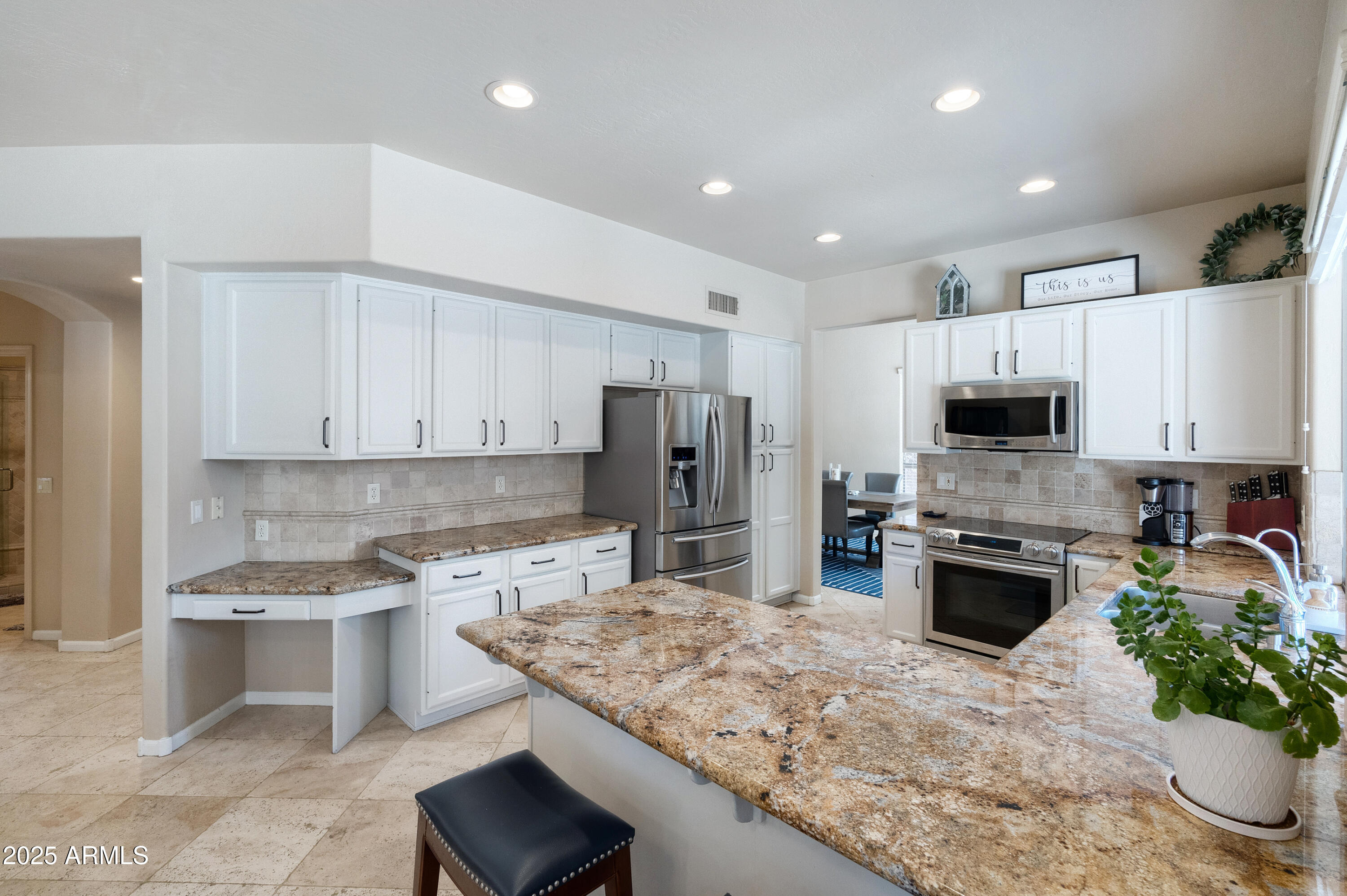 6419 East Betty Elyse Lane Scottsdale, AZ 85254 - Photo 8 of 33 a kitchen with stainless steel appliances granite countertop a refrigerator sink stove microwave and cabinets