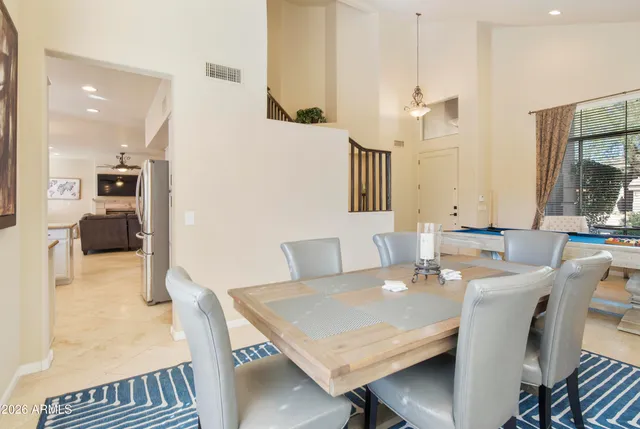 a view of a dining room with furniture and a chandelier