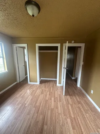 a white toilet sitting next to a tub