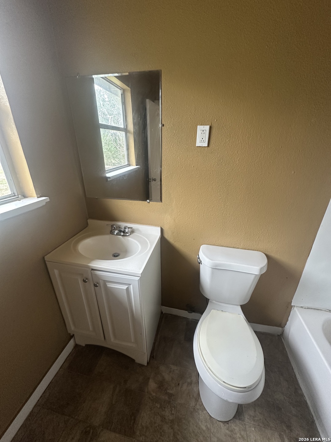 510 Riley Street Seguin, TX 78155 - Photo 16 of 24 a bathroom with a toilet sink and mirror