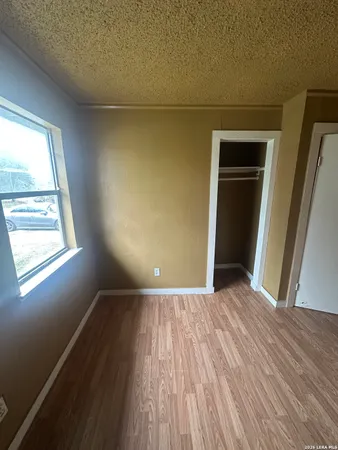 a view of a room with wooden floor