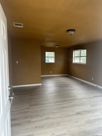 a view of room with window and wooden floor