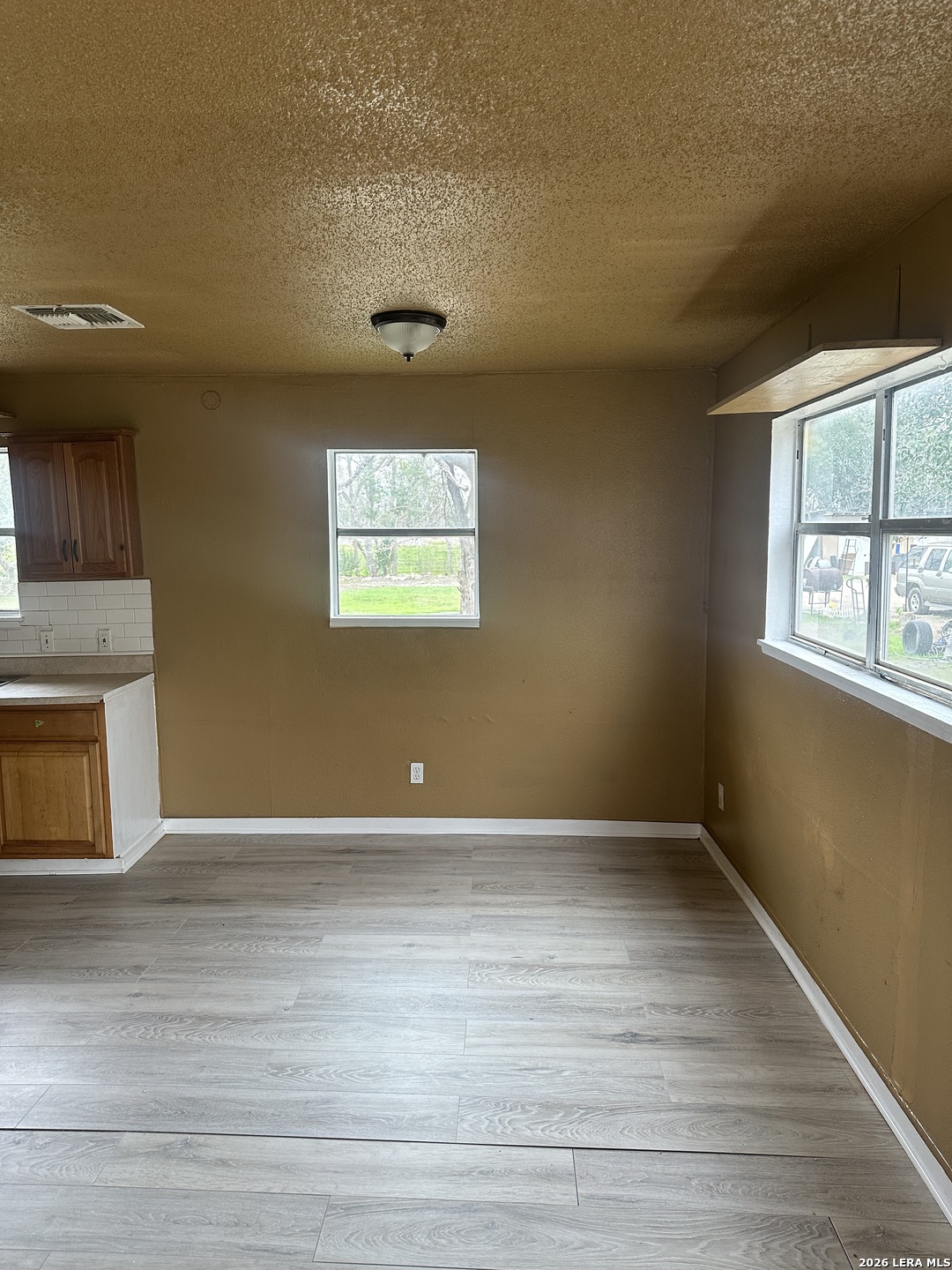 510 Riley Street Seguin, TX 78155 - Photo 6 of 24 an empty room with wooden floor and windows