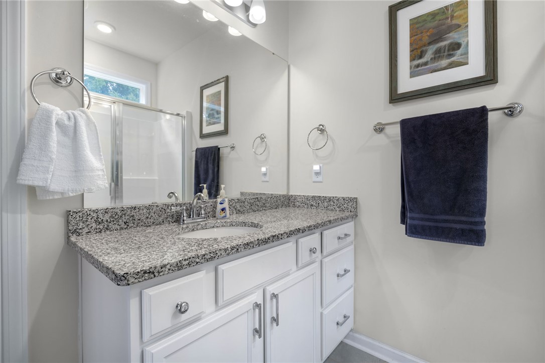 339 Village Boundary Anderson, SC 29621 - Photo 18 of 36 This bright bathroom features a spacious vanity with elegant granite counters and a large mirror.
