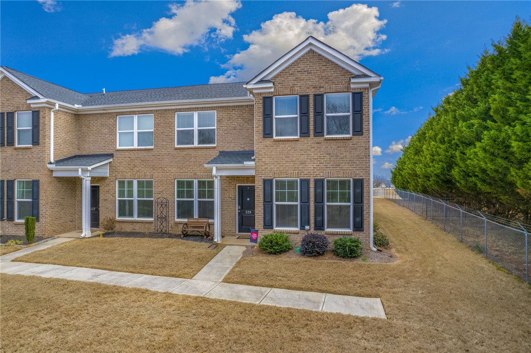 339 Village Boundary Anderson, SC 29621 - Photo 3 of 36 This townhome offers an attractive brick facade with functional shutters and a welcoming entrance.