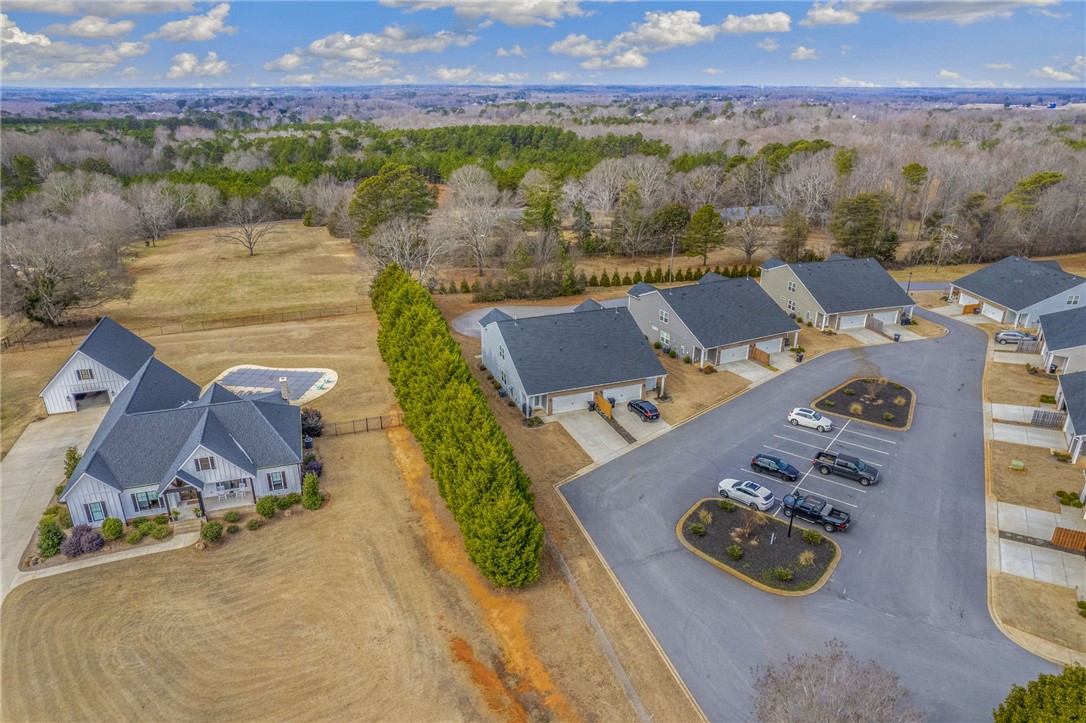 339 Village Boundary Anderson, SC 29621 - Photo 33 of 36 An aerial view showcases a residential community nestled amidst vast open spaces.