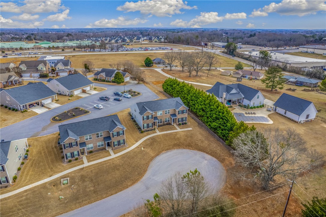 339 Village Boundary Anderson, SC 29621 - Photo 34 of 36 An aerial view captures a quiet residential area surrounded by expansive landscapes and nearby developments.