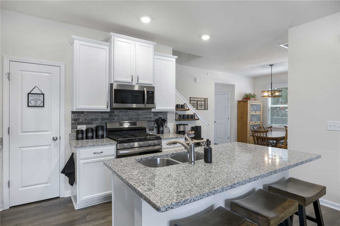 339 Village Boundary Anderson, SC 29621 - Photo 10 of 36 This functional kitchen features ample counter space, modern appliances, and convenient dining access.