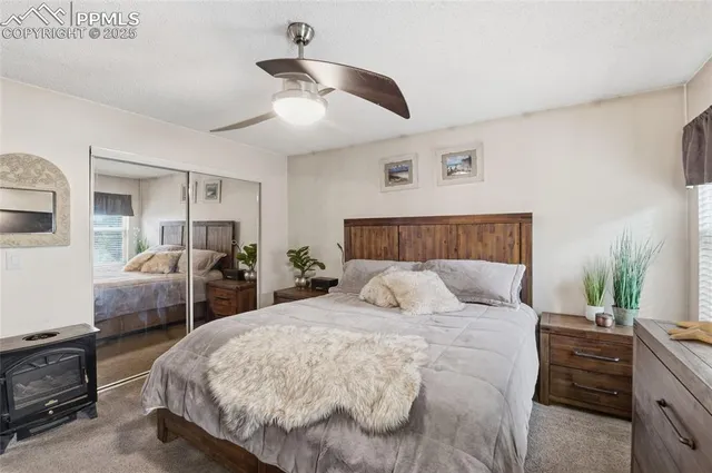 a bedroom with bed and a chandelier