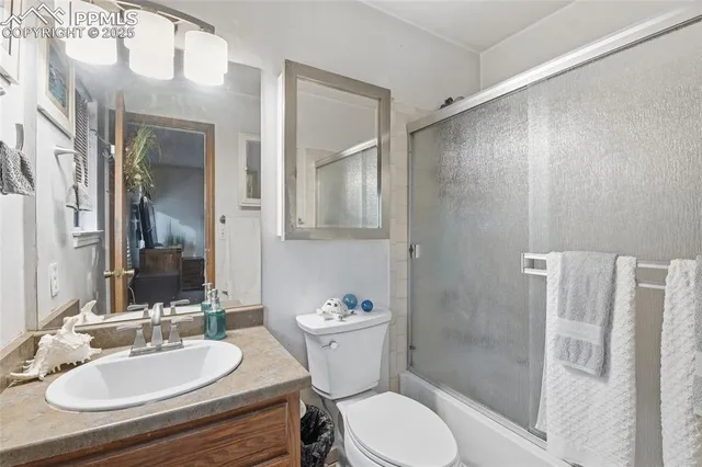a bathroom with a sink toilet a mirror and shower