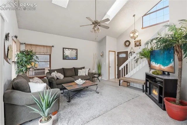 a living room with furniture a fireplace and a potted plant
