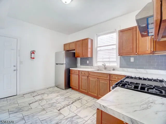 a kitchen with a stove a sink and a refrigerator