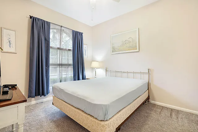 a bed sitting in a bedroom next to a window