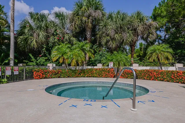 a view of a swimming pool with a patio and plants