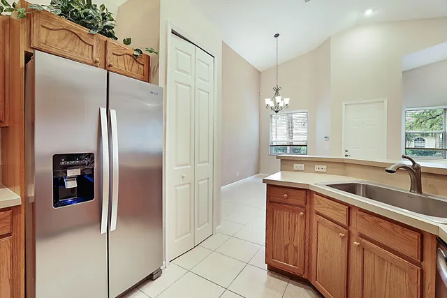 a kitchen with a refrigerator and a sink