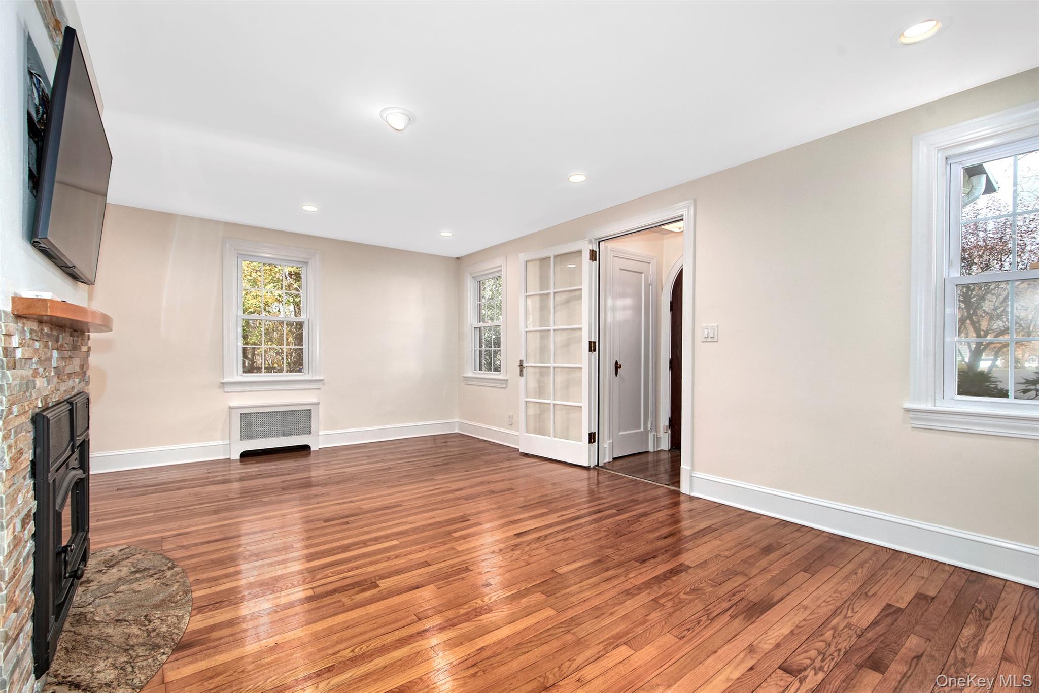 17 Haven Avenue Rye, NY 10580 - Photo 12 of 34 a view of an empty room with a window and fireplace