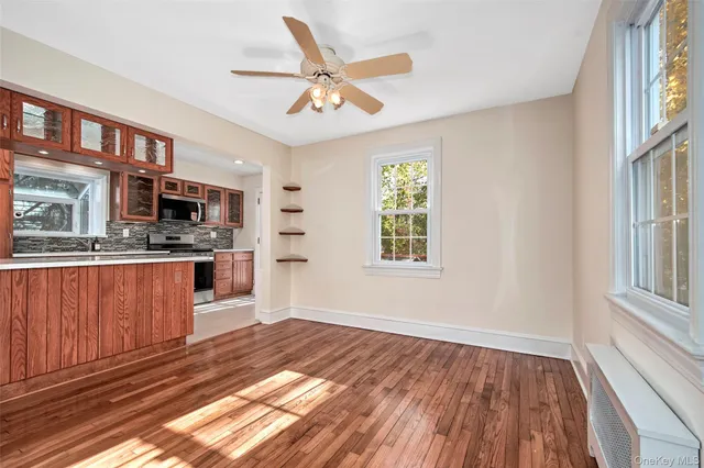 a view of kitchen with stainless steel appliances granite countertop stove a sink dishwasher and a microwave oven with wooden floor