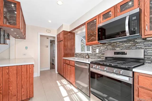a kitchen with stainless steel appliances a stove a microwave oven cabinets and a sink