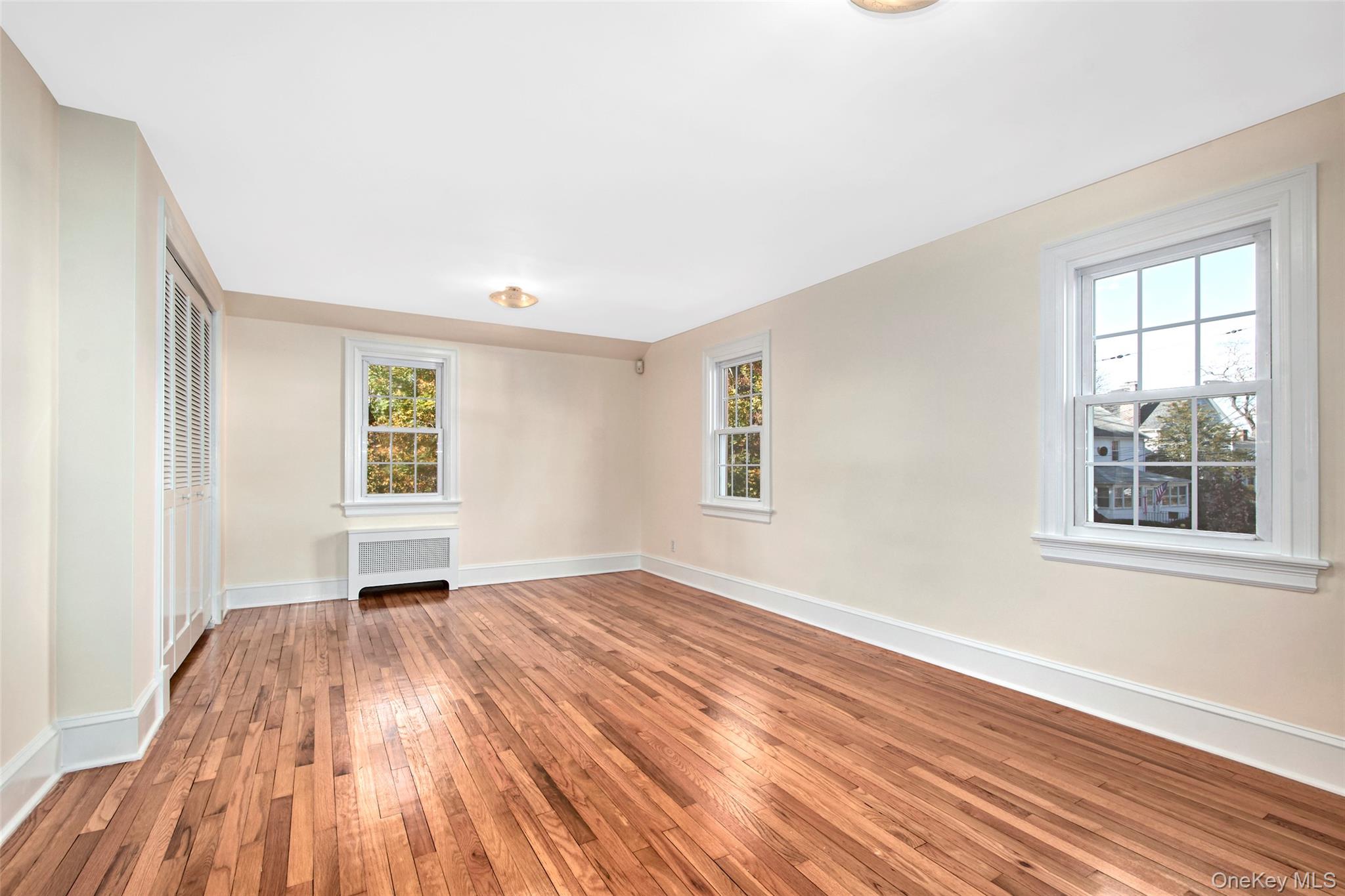17 Haven Avenue Rye, NY 10580 - Photo 20 of 34 wooden floor in an empty room with a window