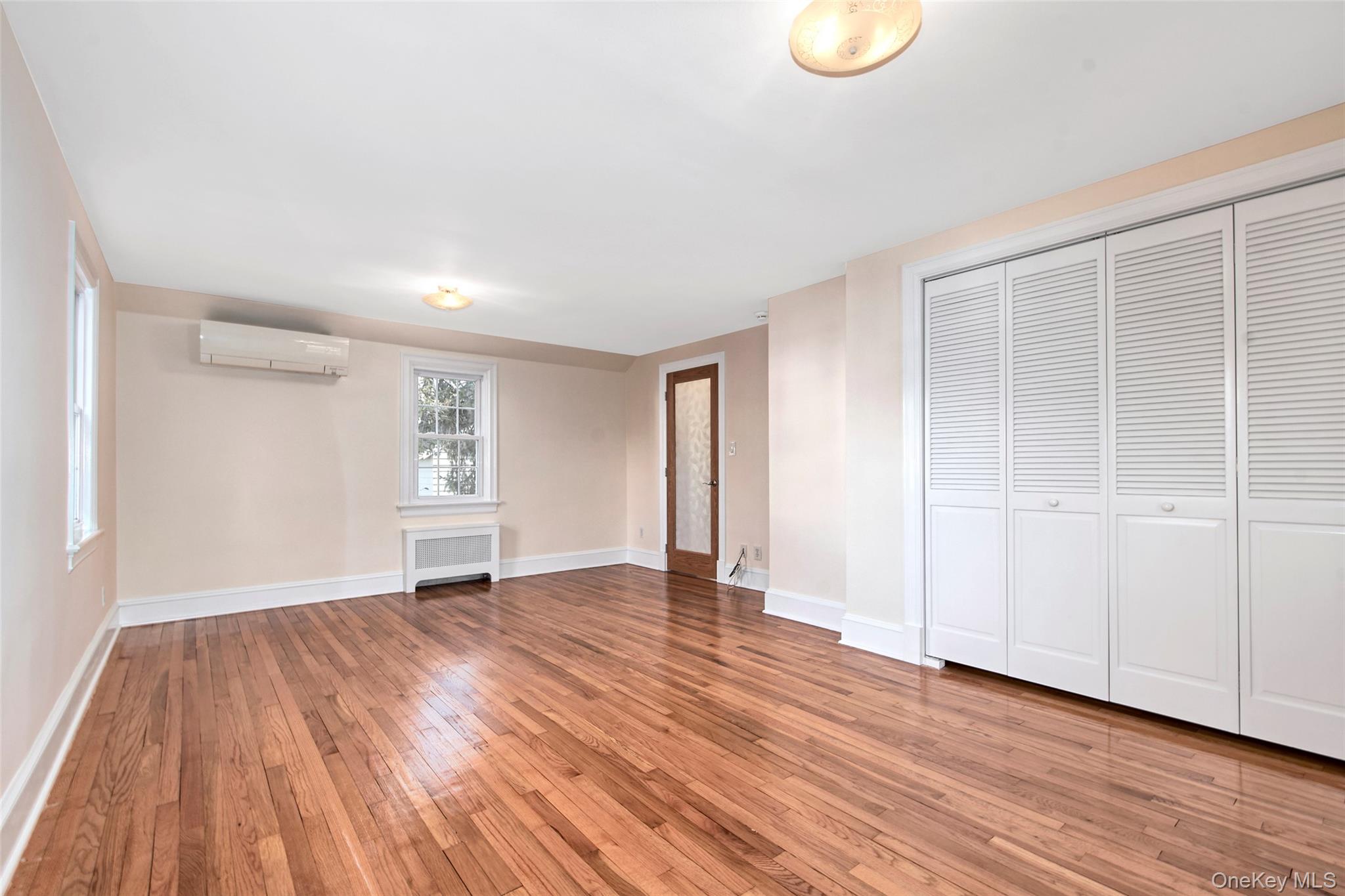 17 Haven Avenue Rye, NY 10580 - Photo 21 of 34 a view of an empty room with wooden floor and a window