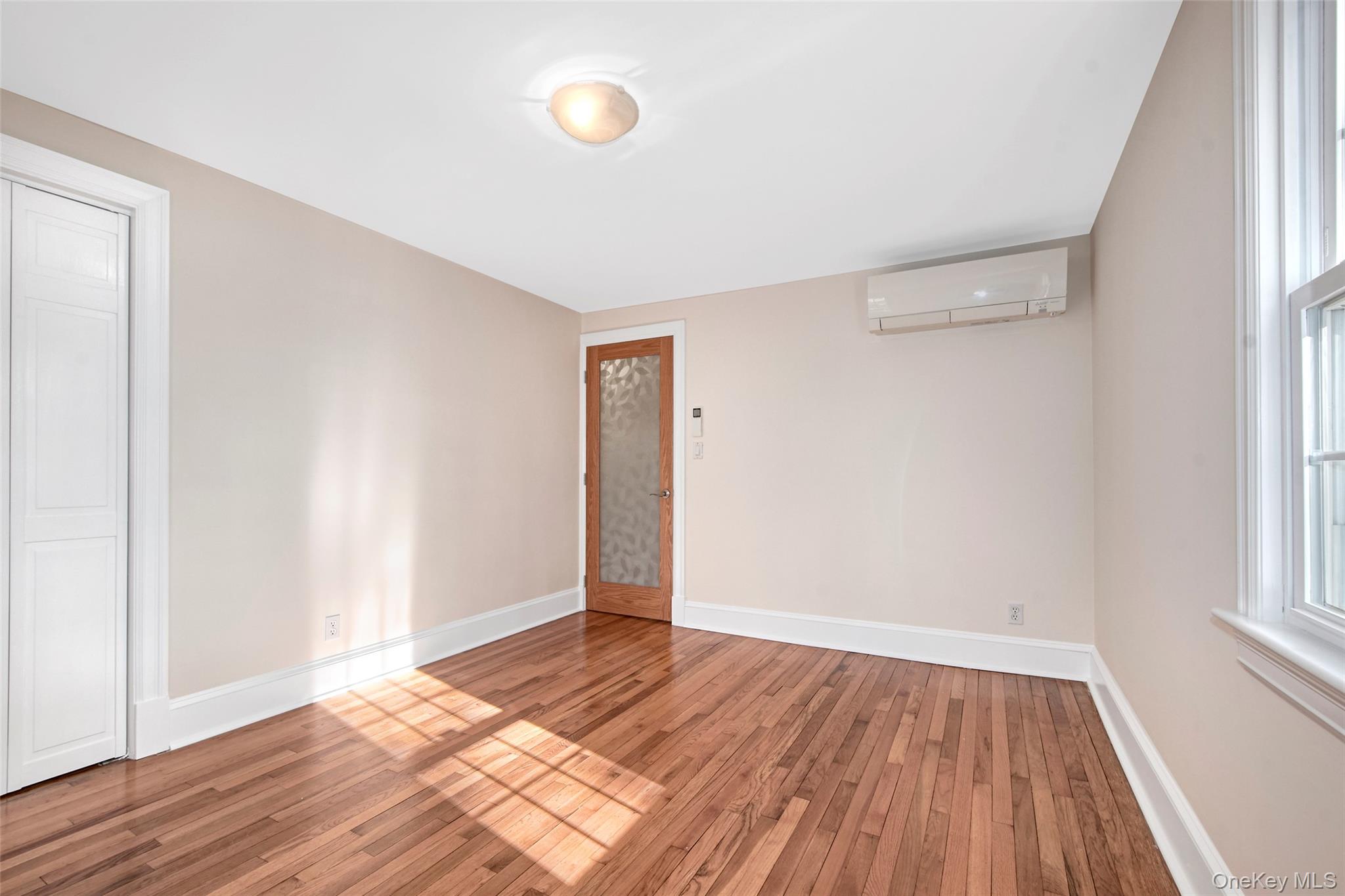 17 Haven Avenue Rye, NY 10580 - Photo 25 of 34 an empty room with wooden floor and windows