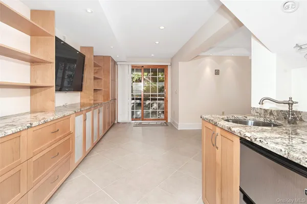 a kitchen with granite countertop a sink stove and cabinets