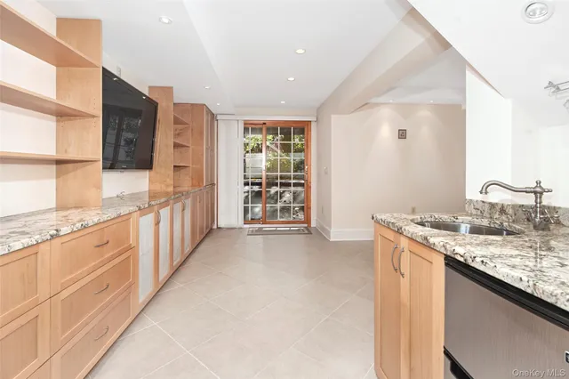 a kitchen with granite countertop a sink stove and cabinets