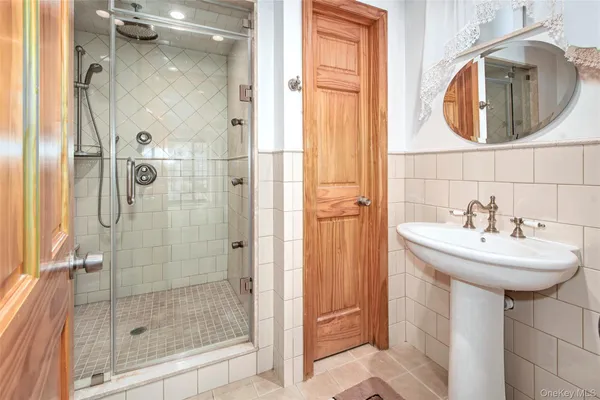a bathroom with a sink a shower and a mirror