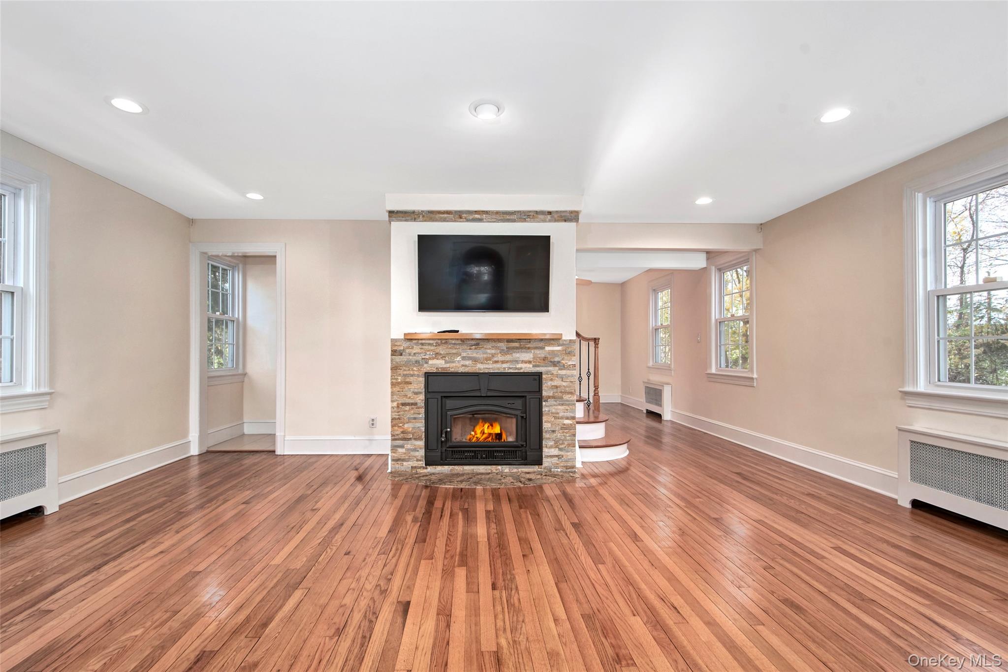 17 Haven Avenue Rye, NY 10580 - Photo 9 of 34 a living room with a fireplace and wooden floor