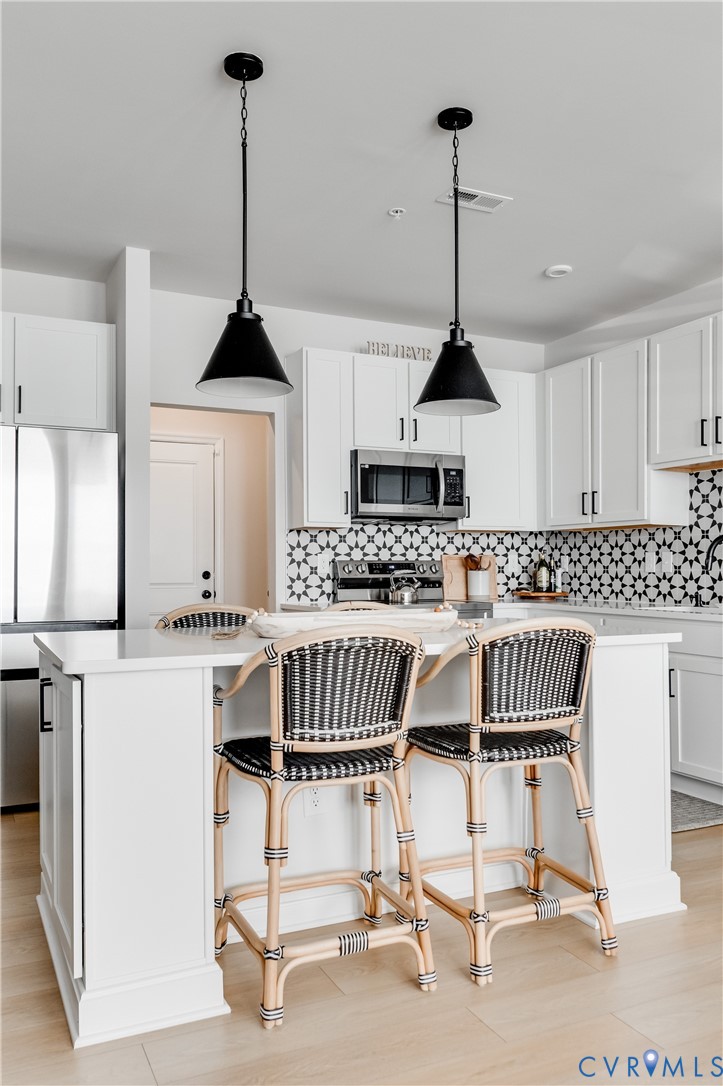 1900 Roseneath Road, Unit 8B Richmond, VA 23230 - Photo 10 of 50 Kitchen with decorative light fixtures, white cabi