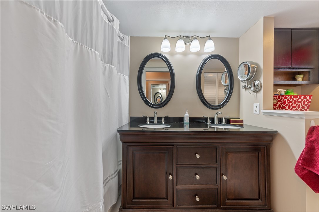 14995 Rivers Edge Court, Unit 250 Fort Myers, FL 33908 - Photo 12 of 19 a bathroom with a sink and a mirror