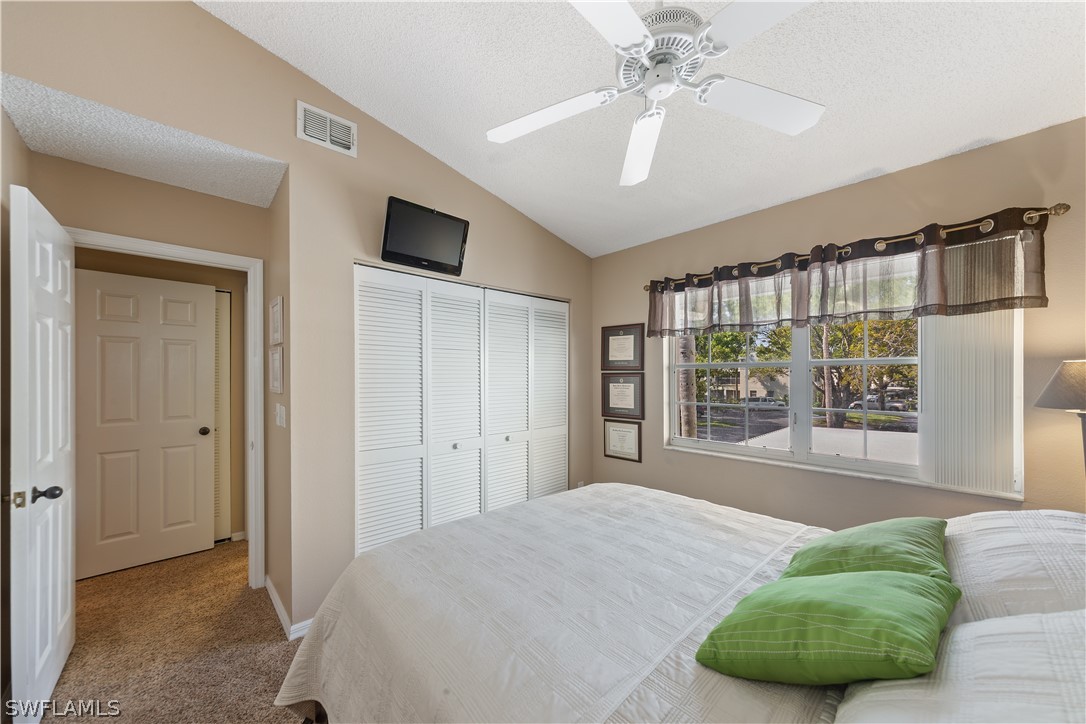 14995 Rivers Edge Court, Unit 250 Fort Myers, FL 33908 - Photo 15 of 19 a spacious bedroom with a bed and a large window