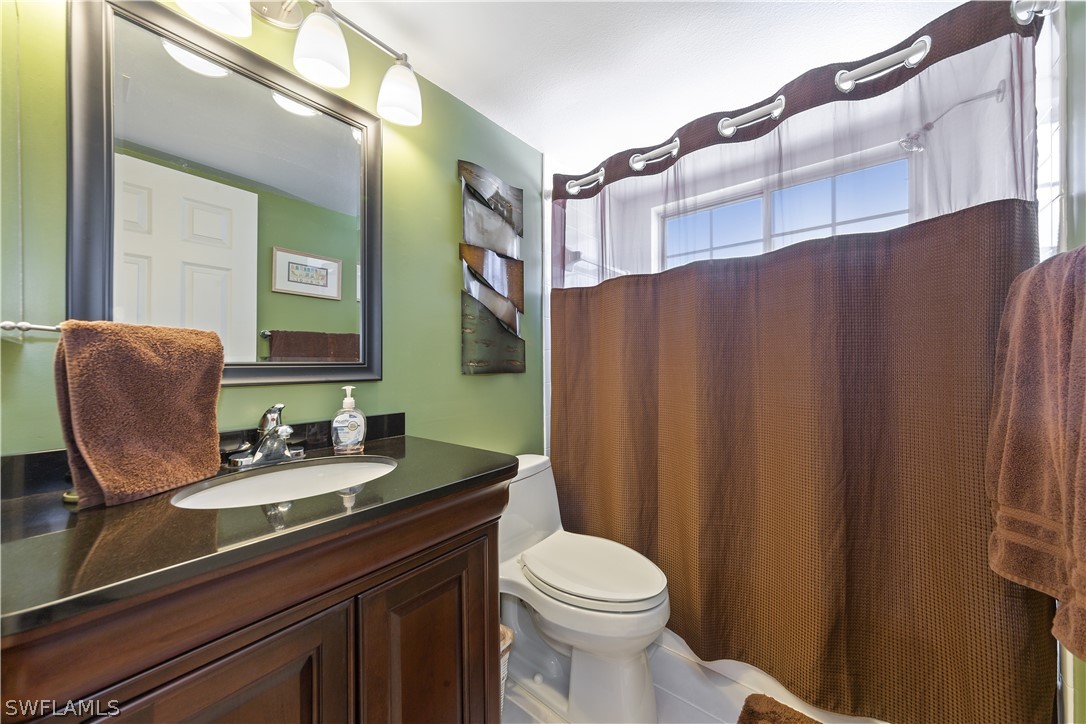 14995 Rivers Edge Court, Unit 250 Fort Myers, FL 33908 - Photo 16 of 19 a bathroom with a sink a toilet and mirror