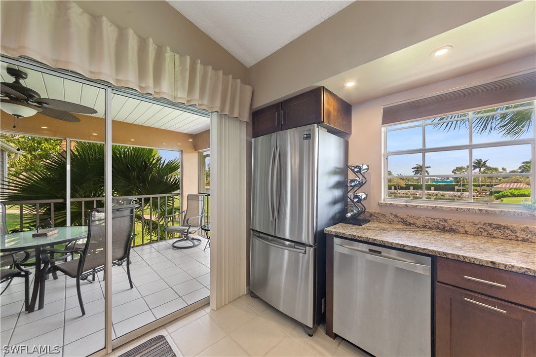 14995 Rivers Edge Court, Unit 250 Fort Myers, FL 33908 - Photo 3 of 19 a kitchen with stainless steel appliances granite countertop a refrigerator and a sink