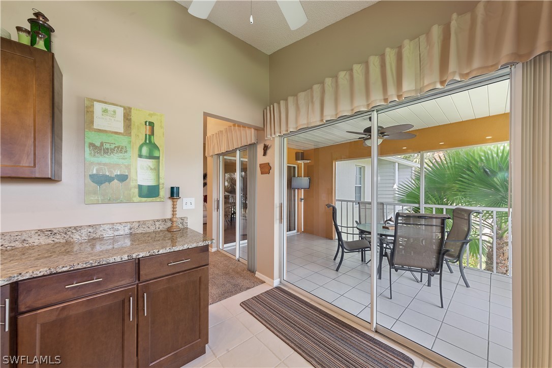 14995 Rivers Edge Court, Unit 250 Fort Myers, FL 33908 - Photo 4 of 19 a dining room with granite countertop furniture and a floor to ceiling window