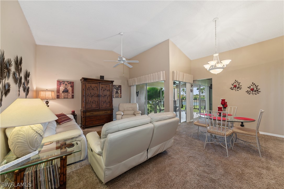 14995 Rivers Edge Court, Unit 250 Fort Myers, FL 33908 - Photo 8 of 19 a living room with furniture a chandelier and a dining table