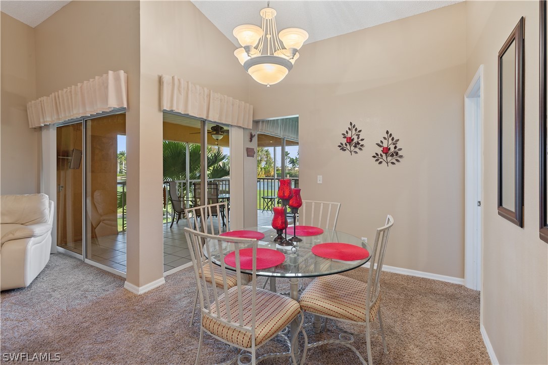 14995 Rivers Edge Court, Unit 250 Fort Myers, FL 33908 - Photo 9 of 19 a view of a dining room with furniture wooden floor and a chandelier